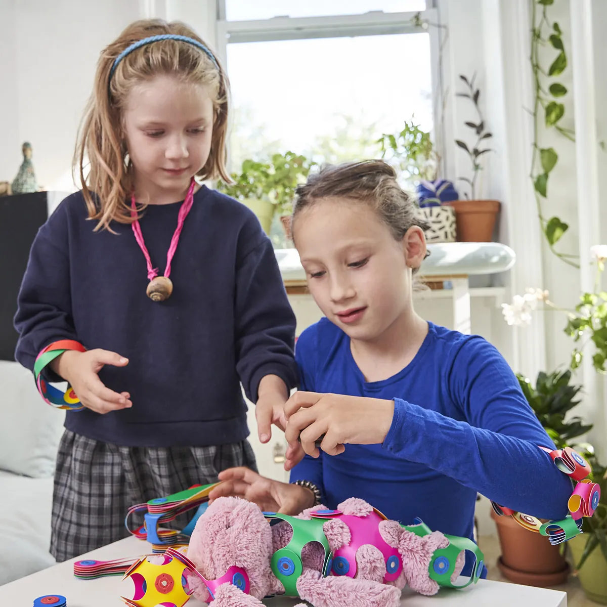 Two girls building a Clixo creation together