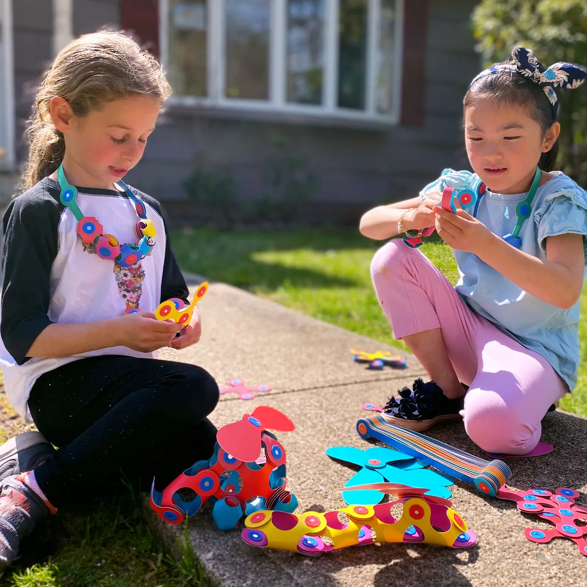 Two children playing with Clixo outdoors